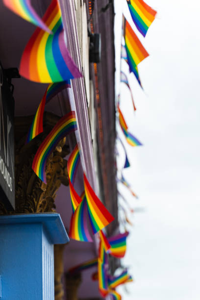 istock Rainbow LGBT flags flutter on the wind as streets decoration and support of equality. Pride flags are representing LGBT community and intersexual diversity. 2189585978