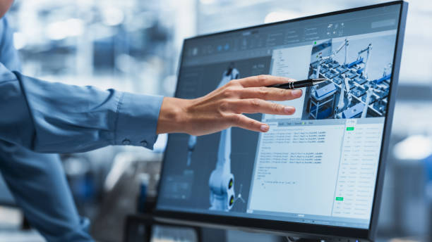 istock Close-Up On Screen Of Desktop Computer With Automation Software For Autonomous Assembly Line At Modern Factory With Robotic Arms. Technical Supervisor Pointing At Display, Adjusting Production Process 2189586024