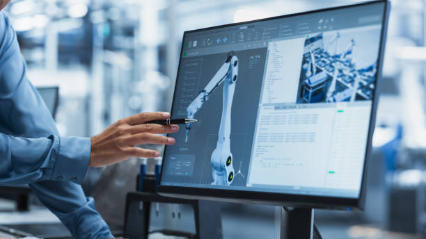 istock Close Up On Screen Of Desktop Computer With Automation Software For Autonomous Assembly Line At Modern Factory With Robotic Arms. Technical Supervisor Pointing At Display, Adjusting Production Process 2189586045