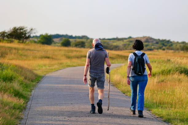 Young happy couple hiking in mountains at summer