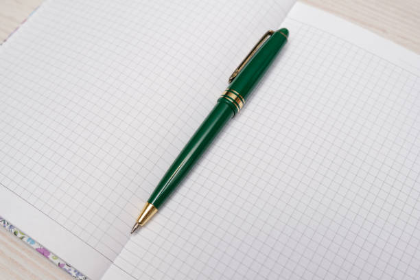 istock A blank notebook with a black pen lying on top. The notebook is open and ready for writing. 2189589023