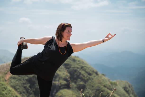 istock Tourist doing yoga pose on sri lanka mountain top 2189592916