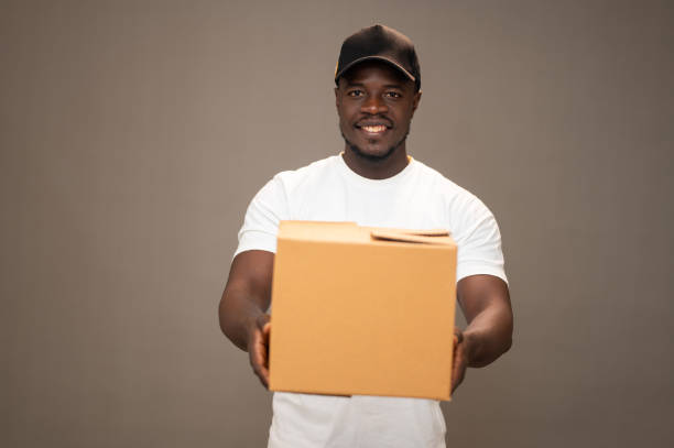 istock Young Black American Dispatch Rider Handling Packages with a Happy Expression 2189593893