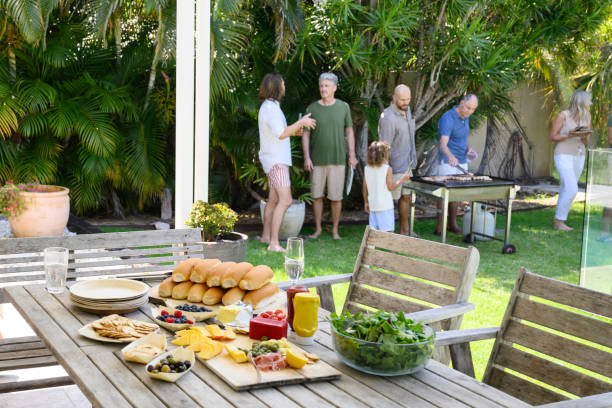 istock Patio table with buns, salad, cheese, and condiments 2189594189