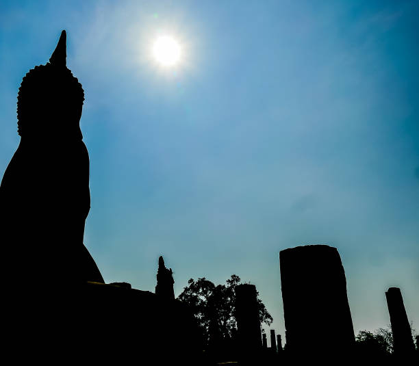 istock A statue of Buddha is silhouetted against a blue sky 2189594558