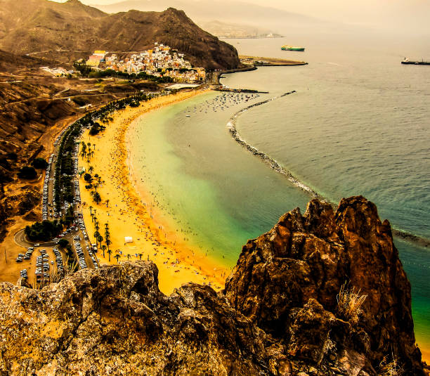 istock A beach with a rocky cliff overlooking the ocean 2189594587