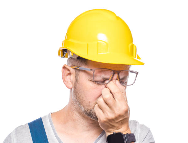 istock Drowsy middle-aged construction worker looking at camera, isolated on white background. Close-up exhausted repairman. Sleepy expression. Craftsman against white wall 2189595869