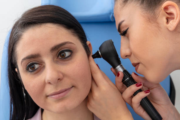 istock Woman doctor getting ear exam at clinic. 2189597596