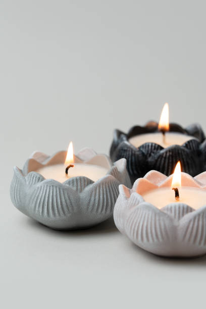 istock Three Elegant Soy Lotus Candles for Relaxation Decor on Neutral Background. Vertical Photography. 2189598382