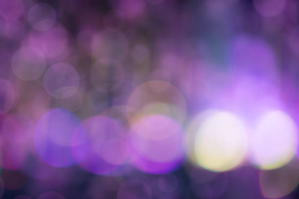 A blurry purple background with a few white circles