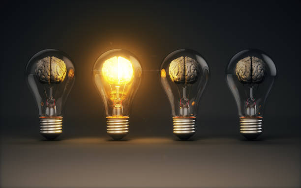 istock Yellow Illuminated Brain Selected Among Gray Human Brains Inside Glass Bulbs on Black Background, Brainstorming on Creative Idea Concept 2189600490
