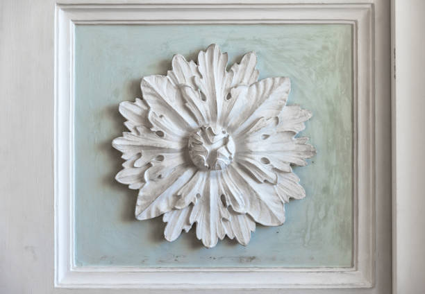 White stucco plafond decoration over green backdrop. Classic wall moulding, vintage style interior details, abstract architectural photo background