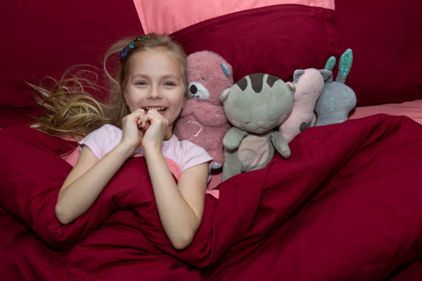 istock little girl in bed 2189601772