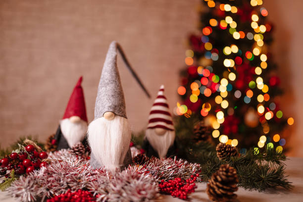 istock Festive Christmas Gnome Decorations with Ornaments and Bokeh Christmas Tree in Background 2189602441