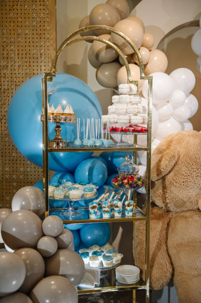 istock Table with sweets, candies, dessert. Arch with bears decoration white, brown, blue balloons. Celebration baptism concept. Birthday party for boy. Trendy winter decor. Delicious reception in restaurant 2189602474