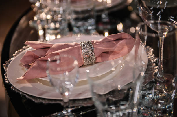 istock Wedding set up, dinner table reception. Plate decorated linen pink napkin and silverware cutlery, glasses. Serving, setting table. Birthday, baptism, event. Luxury silver decor. Side view. Closeup. 2189602848