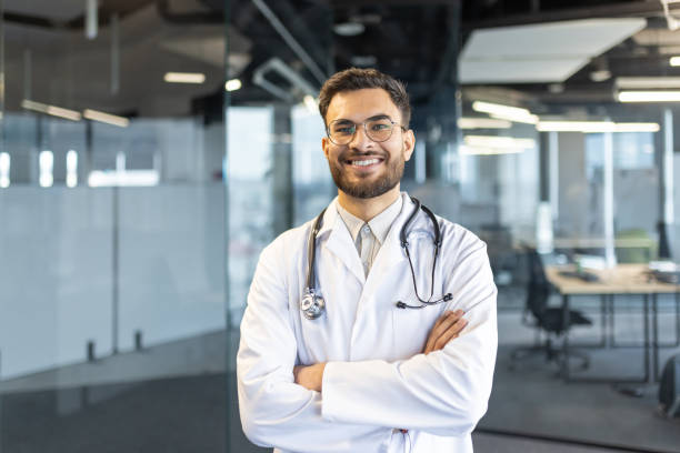 istock Confident male doctor standing with arms crossed in a modern office setting 2189603316