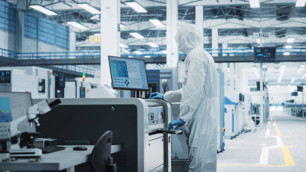 istock Printed Circuit Board Production At Electronics Factory: Scientist In Sterile Suit Using Soldering Jet Printer To Make Motherboards For Powerful Processors. Computer Hardware Manufacturing Concept. 2189603464