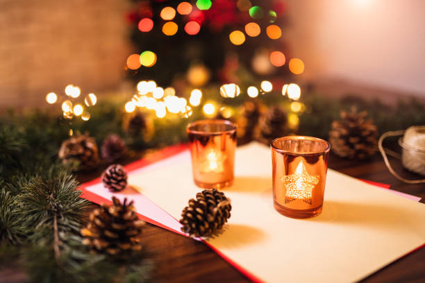 Four yellow beeswax candles with fir cones