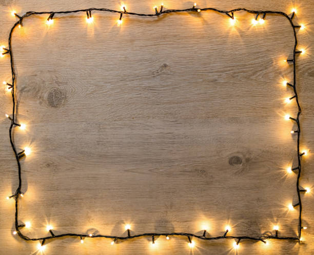 istock Warmly Lit String Lights on Wooden Background for Seasonal Decoration 2189604230