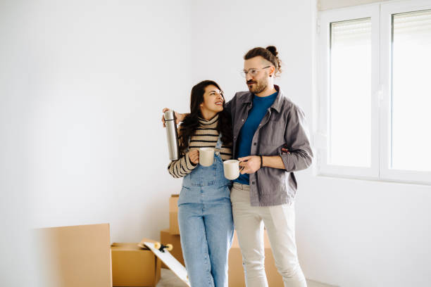 istock Couple drinking first coffee at their new home 2189605256