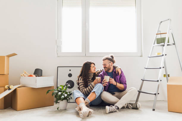 istock Couple drinking first coffee at their new home 2189605447