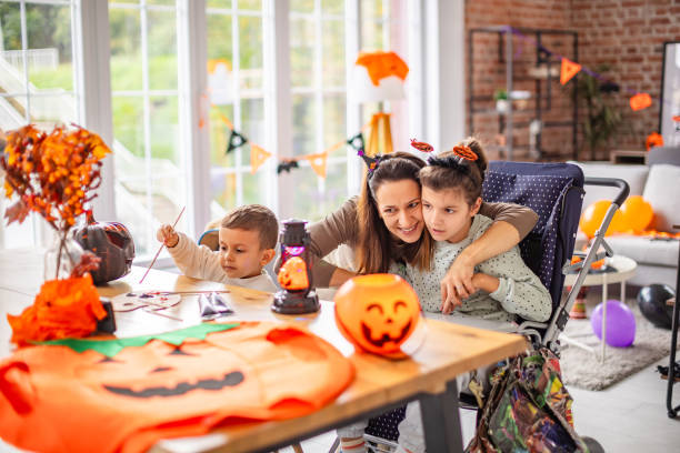 istock Mother helping children create Halloween decorations at home with festive elements 2189607137