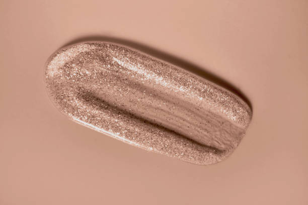 istock Transparent lip gloss tint with sparkles in mocha mousse color 2189607356