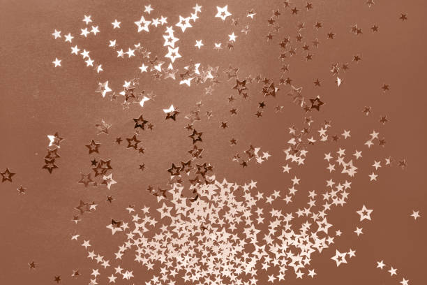 istock Christmas festive background with stars confetti, mocha mousse tinting 2189607436