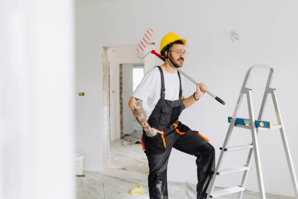 istock Young painter - construction worker painting a wall indoors 2189608776