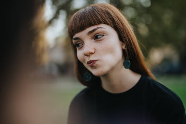istock Young woman with playful expression outdoors in natural light 2189608793