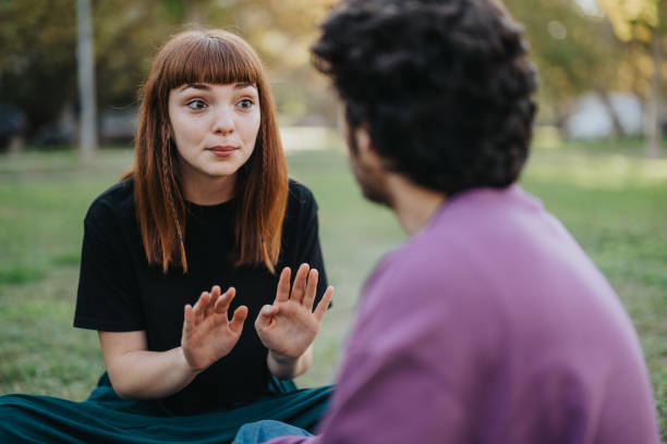 istock Young couple having a conversation in a serene outdoor park setting 2189608810