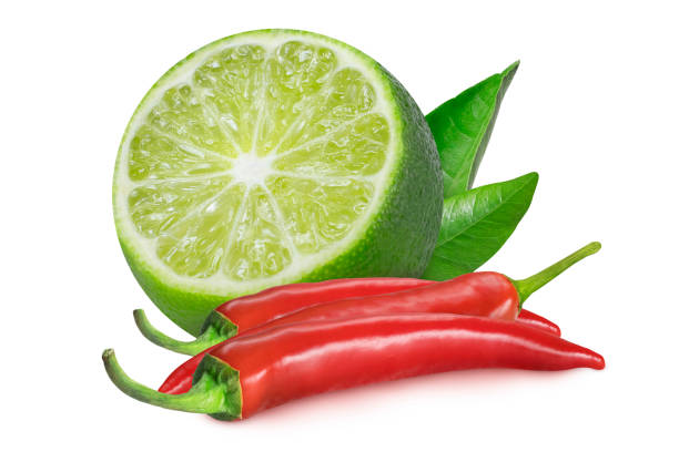 Lime slice with leaves and chili peppers on isolated white background.