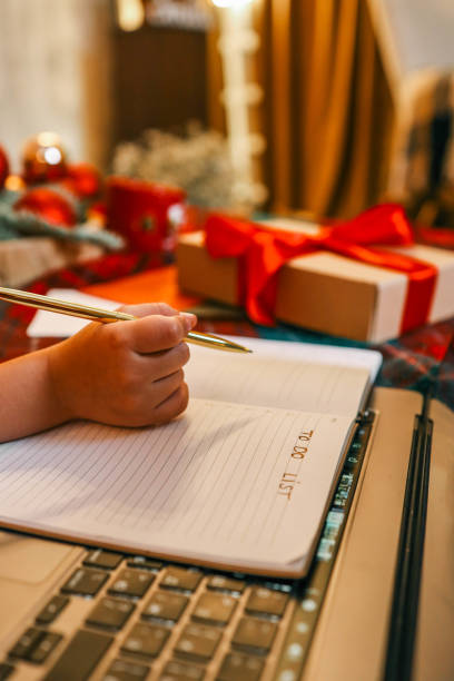 istock Child writes in notebook, Christmas mood 2189609209