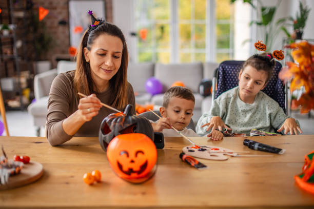 istock Mother and children creating Halloween crafts at a home table 2189609593