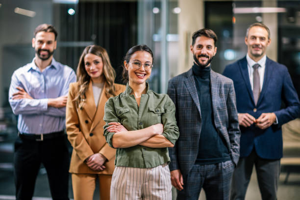 istock Diverse team of professionals posing together in a modern coworking office environment. 2189609868