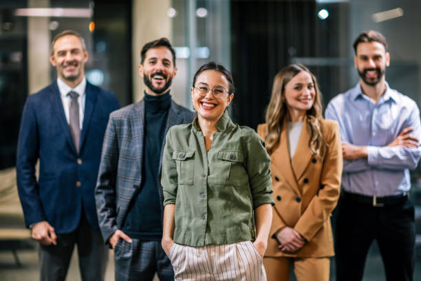 istock Diverse team of professionals posing together in a modern coworking office environment. 2189609882