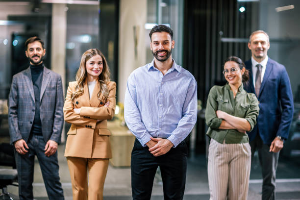 istock Diverse team of professionals posing together in a modern coworking office environment. 2189610731