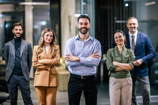 istock Diverse team of professionals posing together in a modern coworking office environment. 2189610733