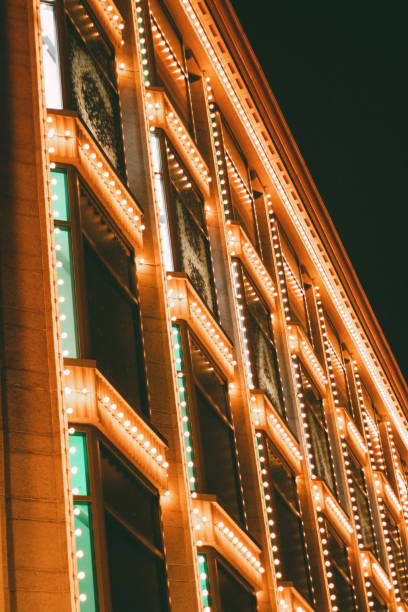 istock Building facade at night adorned with rows of bright, vintage-style marquee lights, creating a festive and glamorous atmosphere. Concepts of entertainment, nightlife, and architectural design. 2189611343