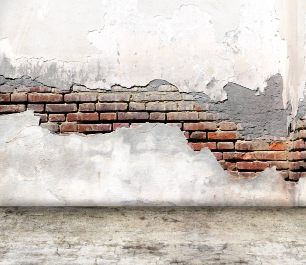 istock Empty interior scene with old brick wall with cracked stucco and concrete floor. Open space with cement wall and floor. Rugged weathered urban wall backdrop. Grunge interior background. 3d render 2189611758