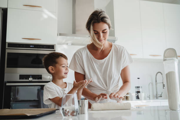 istock Happy mother and her son baking together in a modern kitchen. 2189613356