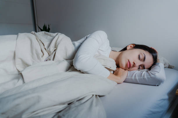 istock Woman sleeping in her bed 2189613387