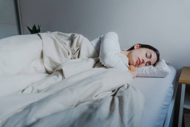 istock Woman sleeping in her bed 2189613406