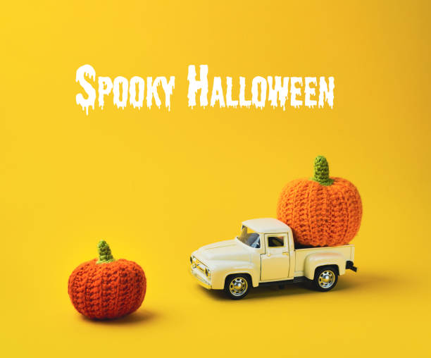 istock White truck is carrying two orange pumpkins 2189614787