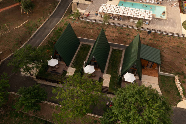 Beautiful aerial view of a serene resort featuring an inviting pool and modern bungalows, Ideal for travel.