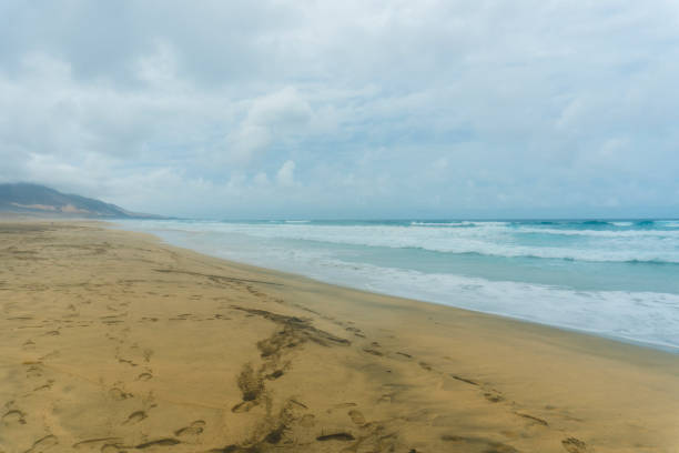 Amazing Playa de Cofete beach with endless horizon. Volcanic mountains and Atlantic Ocean. Cofete beach, Fuerteventura, Canary Islands, Spain.
