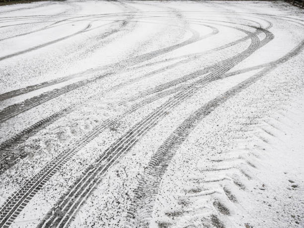 istock Snow-covered ground shows distinct tire tracks from various vehicles in a winter landscape 2189620802