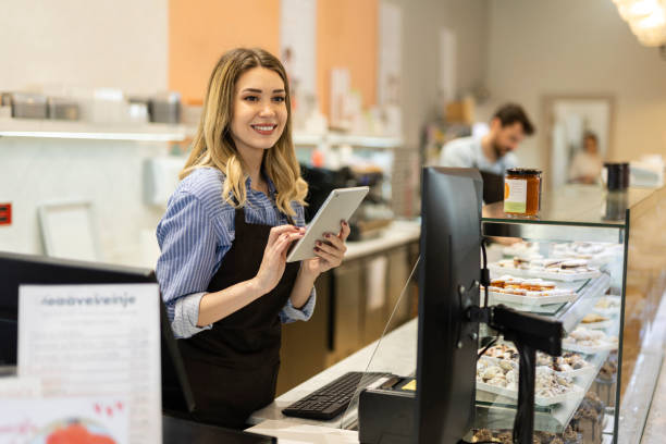 istock Smiling young baker at the checkout counter. 2189622046