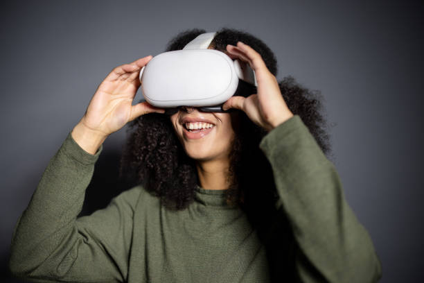 istock Mixed-Race Woman Adjusting VR Headset 2189622829